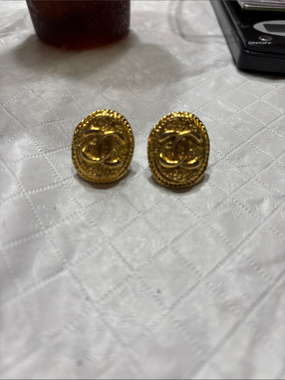 CHANEL Gold Textured Oval CC Logo Earrings